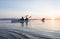 Group of people friends sea kayaking together at sunset in beautiful nature. Active outdoor adventure sports
