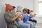 Group of people in funny strange animal masks clapping their hands at conference