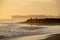 Group of people having horse riding adventure on sand sea beach