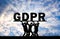 A group of people hold the word GDPR above them