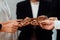 Group of people making chain of gears into collective form for harmony symbol.