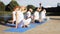 Group of people making yoga exercises outdoors