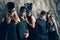 Group of people in masquerade carnival mask posing in studio