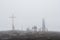 Group of people near cross and monument in the fog