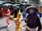 Group of people with painted faces and colorful dresses in the parade of a Festival of the Clans of the Chinese community of Bangk