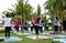Group of people participating Yoga in the park with Logo of fitness first and nike and new balance