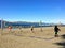 A group of people playing beach volleyball on a beautiful sunny day along the sandy beaches of Spanish Banks, in Vancouver, B.C.