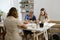 group of people at pottery workshop in cozy studio working with clay