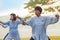 Group of people practice Tai Chi Chuan in a park