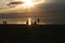 Group of people on public beach over sunset sky in Olhon, Baikal,