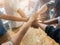 Group of people putting their hands working together on wooden background in office. group support teamwork cooperation concept.