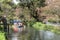 Group of people on raft peddling on serene scenic river