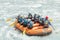 Group of people rafting on white water, active vacations