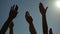 Group of people raising hands, voting outdoors, social community, speech