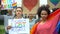 Group of people raising rainbow flags, posters for LGBT rights, gender equality