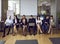 Group of people reading or using laptops while waiting for start of business meeting in office