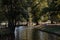 Group of people relaxing in Christ Church Meadow by River Cherwell in Oxford, UK