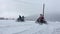 Group of people ride on the snowmobile