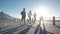 Group of people running on ocean front