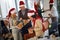 Group of people in santa hat with Christmas present at Xmas business party