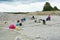 Group of people searching for ammonite fossils in limestone.