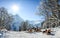 Group of people sitting with deck chairs in winter mountains. Sunbathing in snow. Germany, Bavaria, Allgau
