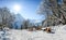 Group of people sitting with deck chairs in winter mountains. Sunbathing in snow. Germany, Bavaria, Allgau