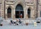 Group of people sitting on the entrance ladders of St. James United Protestant church