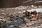 Group of people with snowboards hiking in mountains