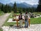 Group of people stand in a field looking at a map while admiring the distant mountain range