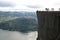 Group of people standing on the edge of a cliff in Preikestolen, Norway