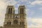 A group of people standing in front of Notre Dame de Paris in the background