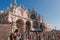 Group of People Standing in Front of Ornate Cathedral in Venice, Italy on Unknown Day.