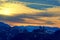 Group of people stands on the top of rock. Beautiful sunset cloudscape background. Greek Meteora mountains, winter landscape