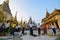 A group of people suddenly together sweep the floor in one long line in Shwedagon Pagoda