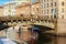 A group of people on SUP boards floats along the Moika River in the center of St. Petersburg