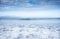 Group of people on the surfboard waiting for the waves.  Day with clouds. An island on the horizon. Concept of freedom and