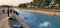 Group of people in Swabi, Pakistan having a good time jumping into a river of fresh blue water