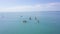 Group of people swim on SUP Board. Clip. Beautiful seascape with people resting on water with SUP boards. Top view of