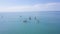 Group of people swim on SUP Board. Clip. Beautiful seascape with people resting on water with SUP boards. Top view of