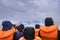 A group of people is taking a boat trip to Jokulsarlon Glacier Lagoon in Iceland. The boat surrounded by icebergs