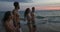 Group Of People Talking While Walking On Summer Beach In Twilight, Friends Communication Young Mix Race Men And Women