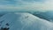 Group of People on Top of Snow-Capped Mountain in European Alps. Aerial View