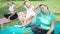 Group of people training yoga sitting on mat at park