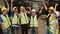 Group of people in uniforms and helmets in warehouse: workers of various races such as Caucasian, black, and Asian