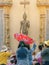 Group of people wait for coins wrapped in ribbons from new monk in ordination ceremony tradition