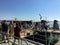 A group of people waiting to board a water ferry or vaporetto on Murano Island, just above Venice, Italy,