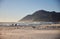 Group of people walking along Noordhoek beach. Cape Town, South Africa.