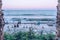 A group of people watching the waves in the evening at sunset. The beach, moment of reflection.