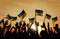 Group of People Waving Ukrainian Flags in Back Lit